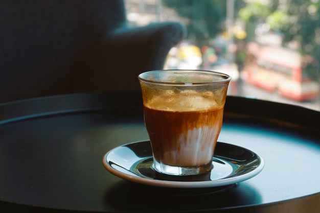 Iced dirty coffee on black table