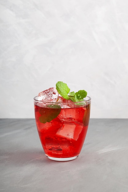 Iced fruit red cocktail or cold watermelon drink with hibiscus and mint leaf Refreshing drink