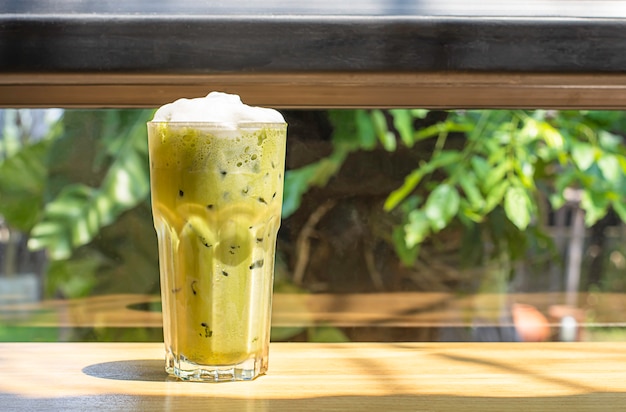 Iced green tea  in glass on the wooden table 