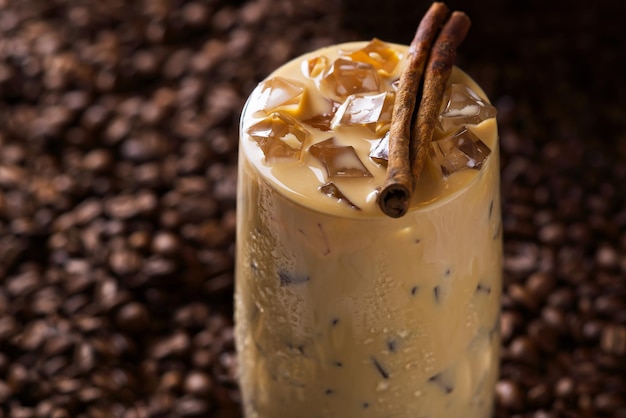 Iced latte coffee Cup of Iced latte coffee milk tea on dark coffee seeds background