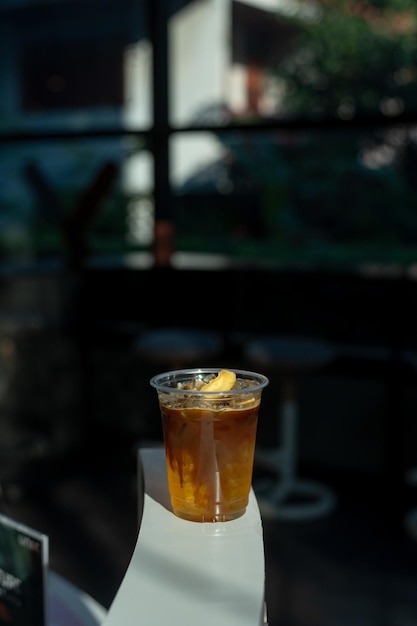 Iced Latte Coffee in a Plastic Glass on a Black Table at a Coffee shop