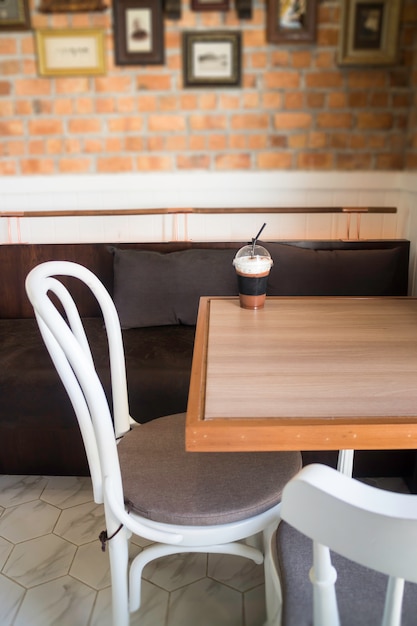 Iced milk froth coffee serving on wooden table