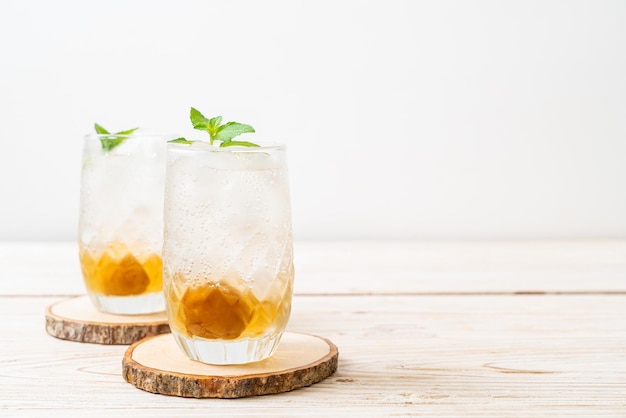 Iced plum juice with soda and peppermint