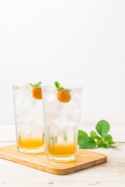 Iced plum juice with soda and peppermint