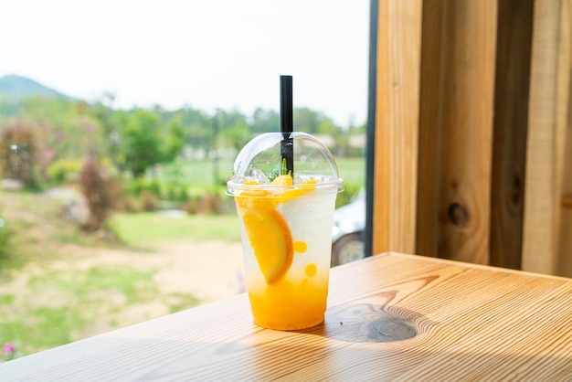 Iced soda with yuzu orange in glass with copy space