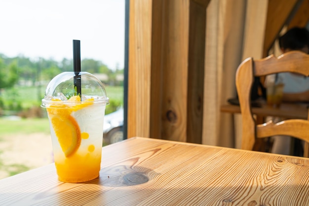 Iced soda with yuzu orange in glass