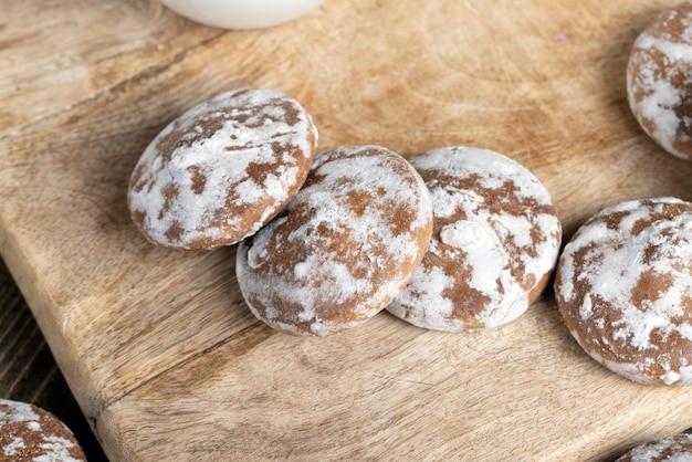 Iced sugar gingerbread on a cutting board flour pastry made of gingerbread flour covered with sugar