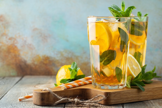 Iced tea with lemon and ice in tall glasses.