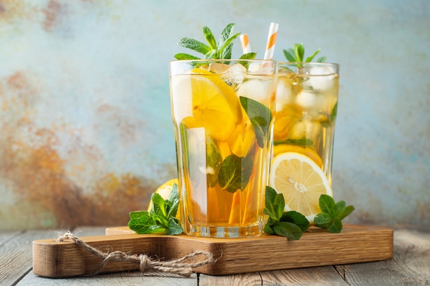 Iced tea with lemon and ice in tall glasses.