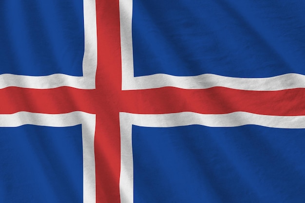 Iceland flag with big folds waving close up under the studio light indoors The official symbols and colors in banner