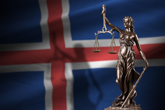 Iceland flag with statue of lady justice and judicial scales in dark room Concept of judgement and punishment