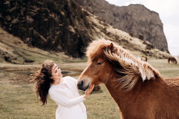 Icelandic horse and woman in a white dress