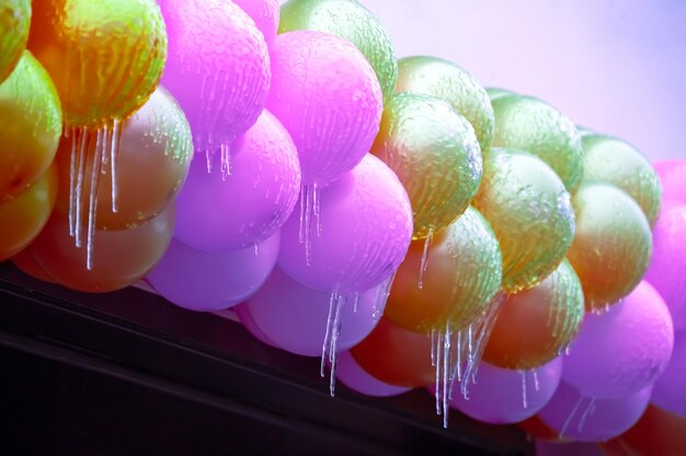 icicles on frozen colored inflatable holiday balls winter weather season street interior details