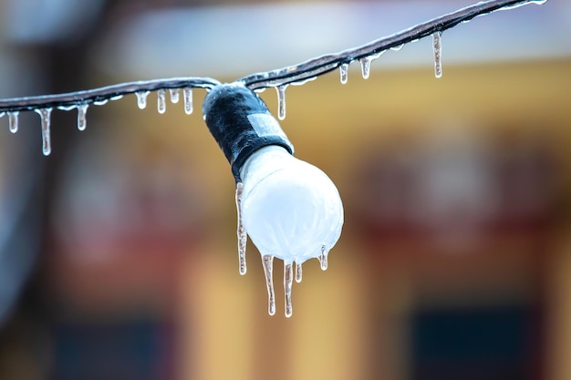 Icicles on frozen street lighting lamps winter weather season street interior details object of electricity