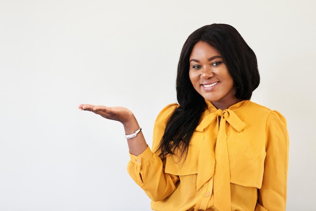 Id highly recommend you take a look sometime Studio portrait of a cheerful young woman standing with her hand raised against a white background