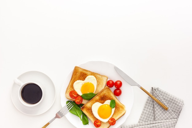 Idea for the celebration of Valentine's day: breakfast - toast with scrambled eggs in the form of hearts