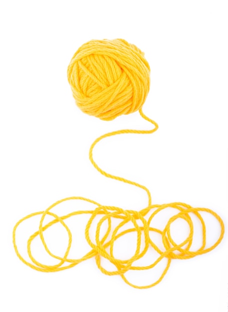 The idea is a tangled thread. Yellow ball of yarn on white isolated