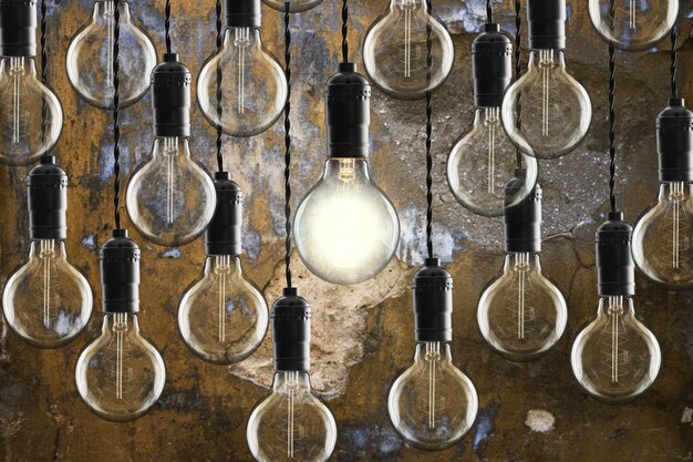 Idea and leadership concept Vintage bulbs on wall background