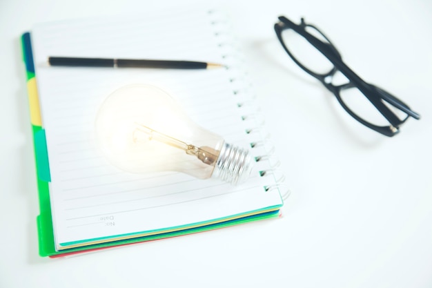 Idea or light bulb on notepad