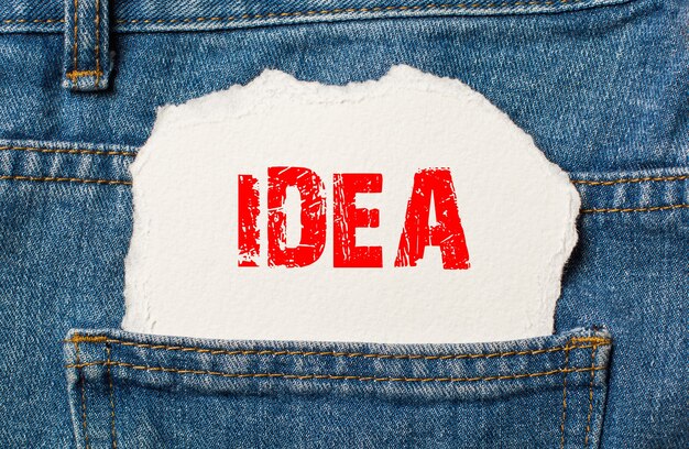 Idea on white paper in the pocket of blue denim jeans