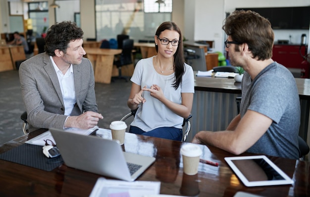 THe ideas are flowing Shot of three coworkers talking together in an office