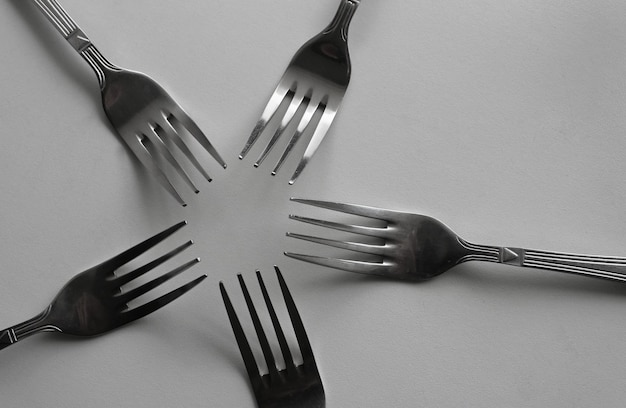 Identical Silvery Table Forks In Form Of Star Concept Photo For Design Or Backgrounds