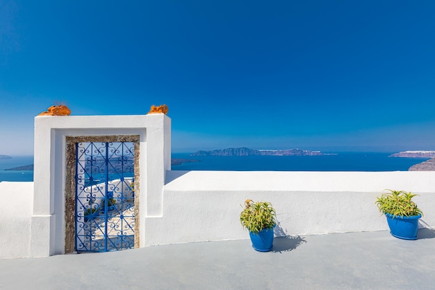 Idyllic door, gate or entrance white architecture over sea view on Santorini Island in Oia. Travel