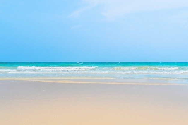 Idyllic perfect tropical white sandy beach and turquoise clear ocean water - summer vacation natural background with blue sunny sky