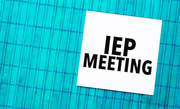 Iep meeting word on torn paper with blue wooden background