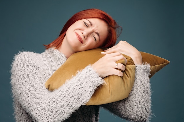 Ill woman having terrible headache and holding hand on forearm.