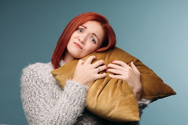 Ill woman having terrible headache and holding hand on forearm.