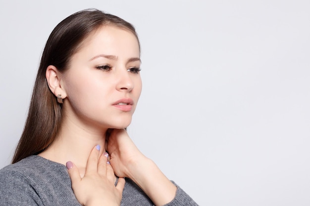 Illness Health Care people Medicine concept Throat Pain Closeup Of Sick Woman With Sore Throat Feeling Bad Suffering From Painful Swallowing Beautiful Girl Touching Neck With Hand