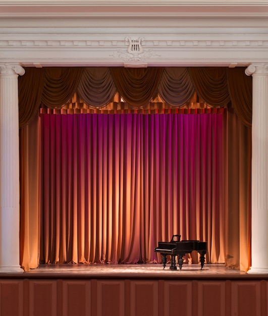 Illuminated by lights stage with backstage and decorative columns