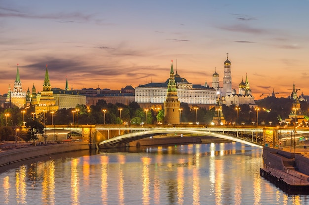 Illuminated Moscow Kremlin and Moscow River with bridge in the early summer morning. Russia