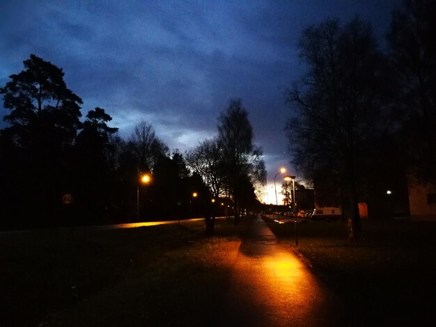 Photo illuminated road against sky at night