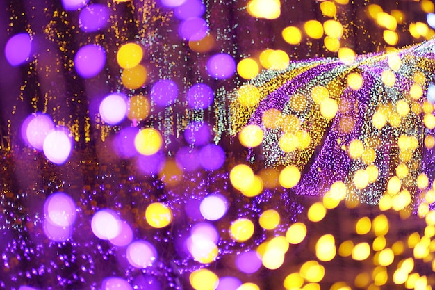 Illuminated violet and golden bokeh circular light diffused background