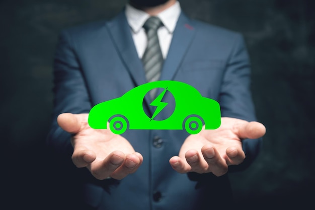 Illustrated green electric car Man holding in his hand