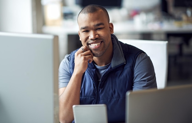 Im in the business of being happy Portrait of a young designer sitting at his desk