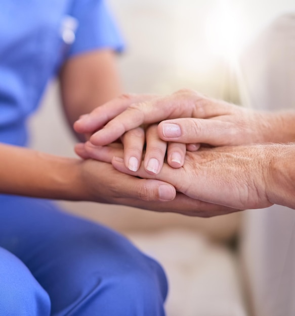 Im here to help Cropped shot of a nurse holding a senior womans hands in comfort