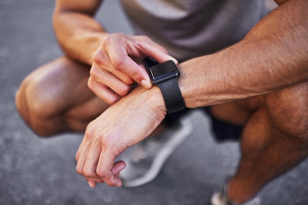 Im making some good progress over here Cropped shot of an unrecognizable man crouching down and setting a timer on his watch before running outside