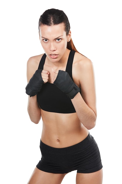 Im up for the challenge Cropped portrait of a young female athlete kickboxing against a white background