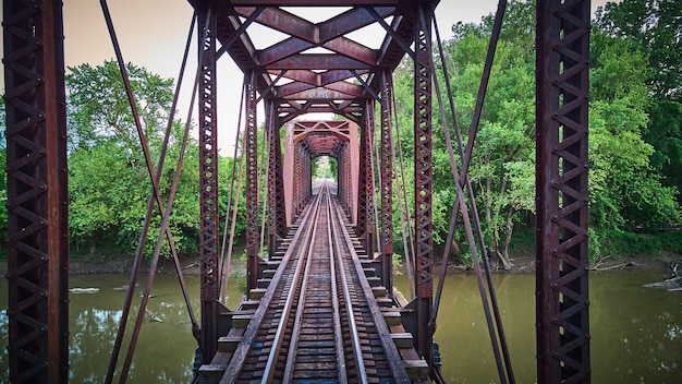 Image of Aerial of train tracks over river with metal frame