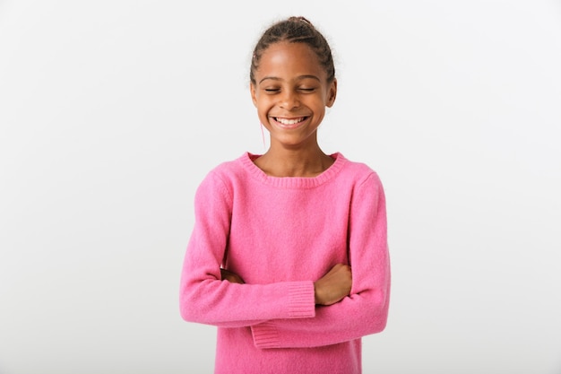 Image of african american happy girl laughing and posing with hands crossed isolated over white wall