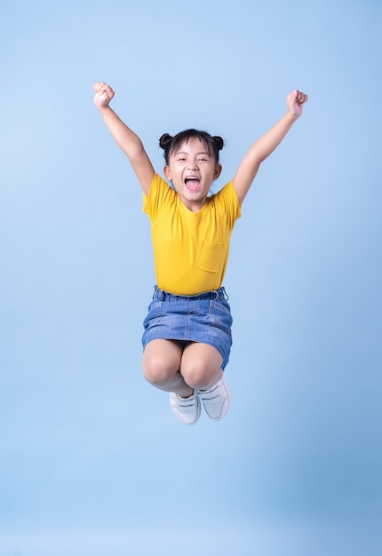 Image of Asian child posing on blue background