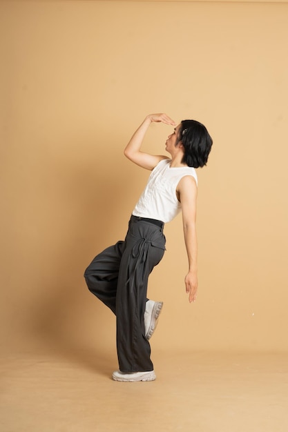 Image of Asian dancer dancing on beige background