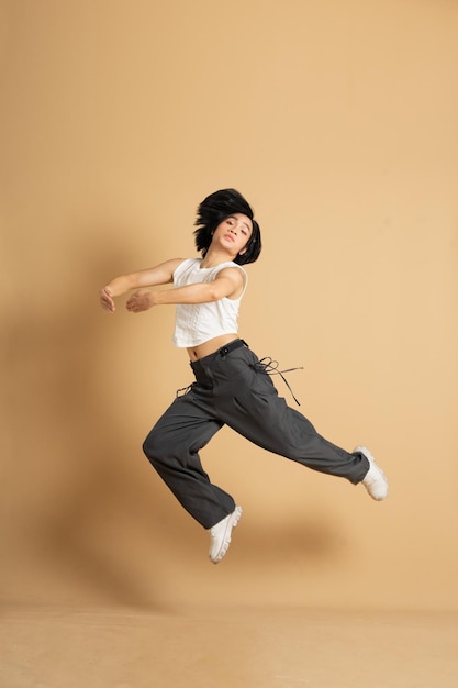 Image of Asian dancer dancing on beige background