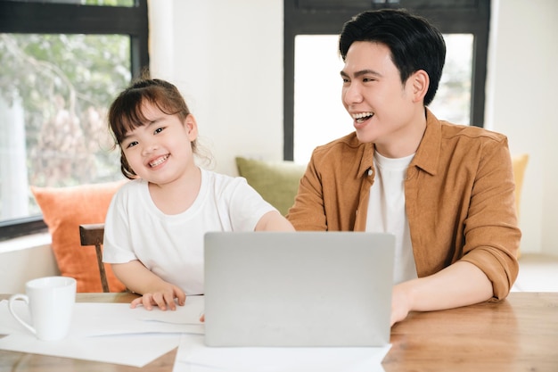 Image of Asian father and daughter at home