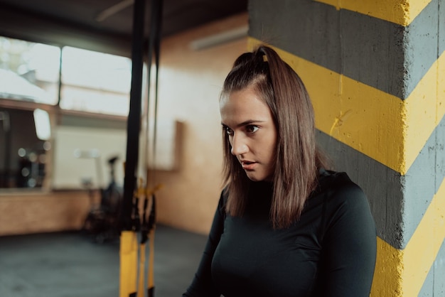 Image of attractive fit woman resting and posing in the gym