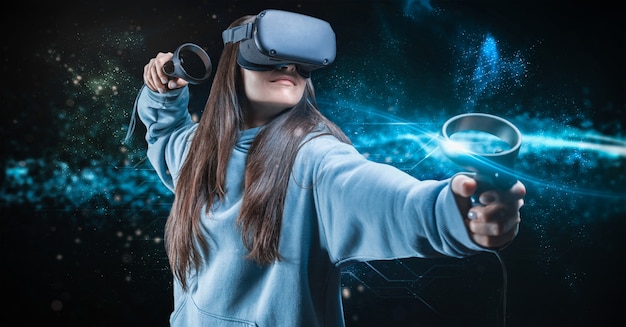 Image of a beautiful stylish woman wearing VR glasses and holdin