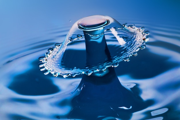 Image of Beautiful umbrella of water from water collision on blue water